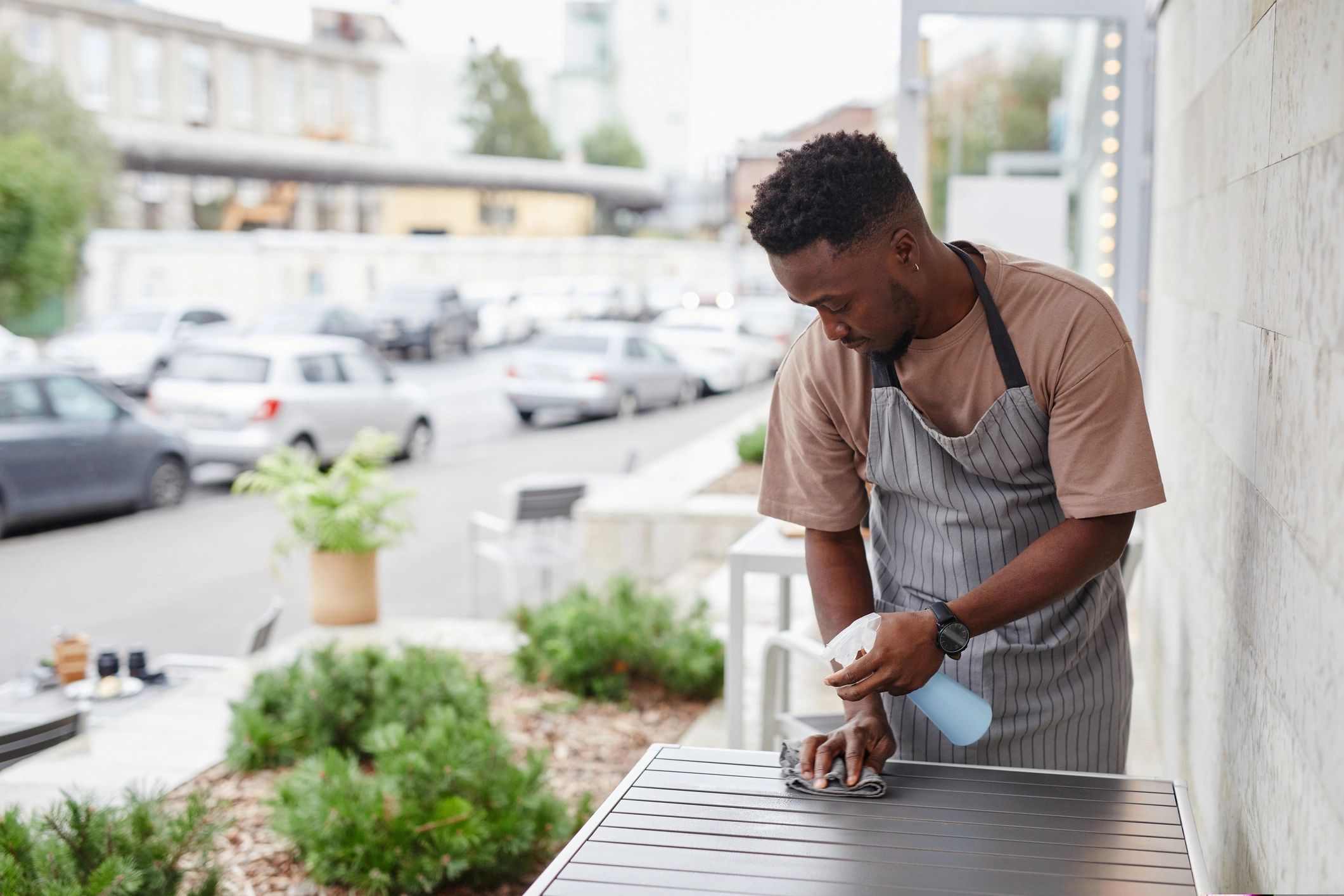 Professional cleaner wiping tables in a commercial setting